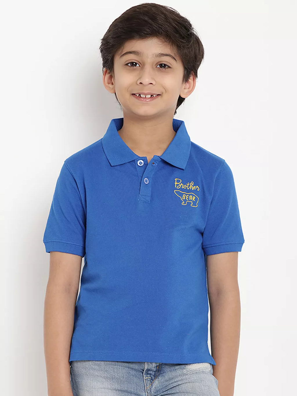 Child wearing a blue polo shirt with a logo on a white background