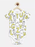 White baby onesie with yellow alphabet and pencil print on a hanger against a white background