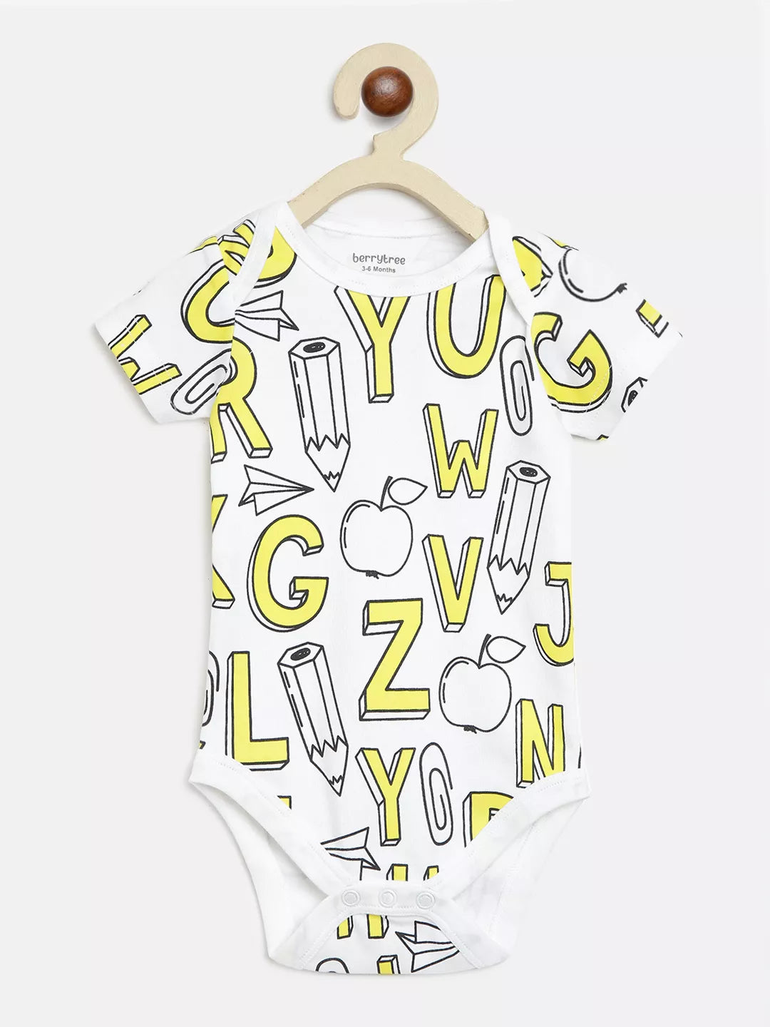 White baby onesie with yellow alphabet and pencil print on a hanger against a white background