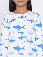 Child wearing a long-sleeve shirt with blue shark and 'HELLO' print on a white background