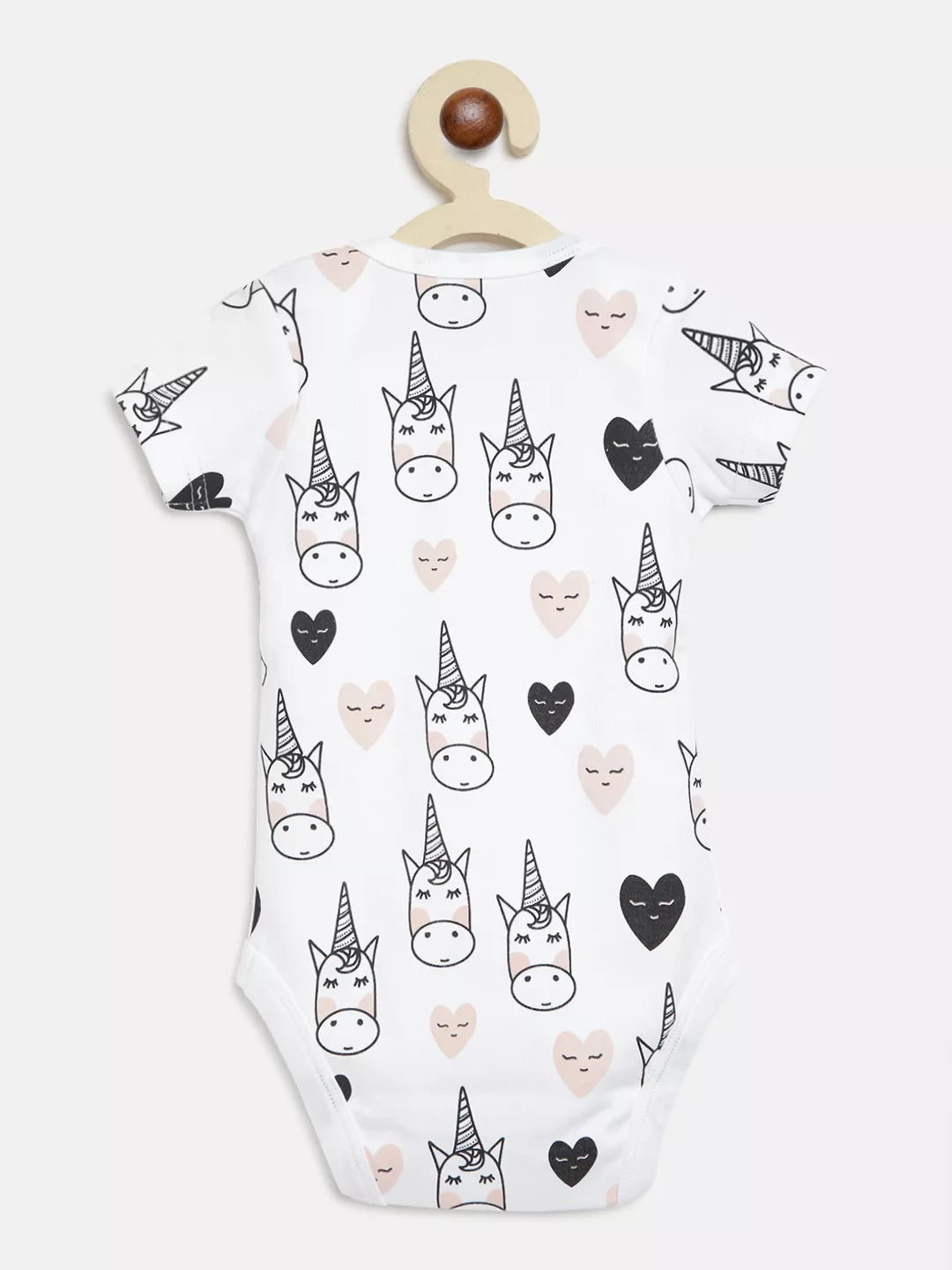 Baby onesie with unicorn and heart pattern on a white background