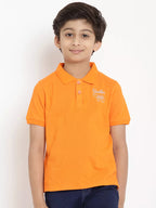 Child wearing an orange polo shirt with a logo on a white background
