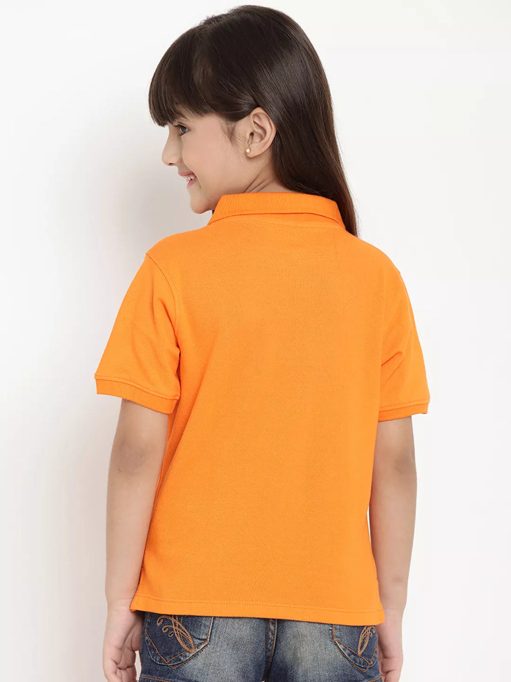 Child wearing an orange polo shirt against a white background