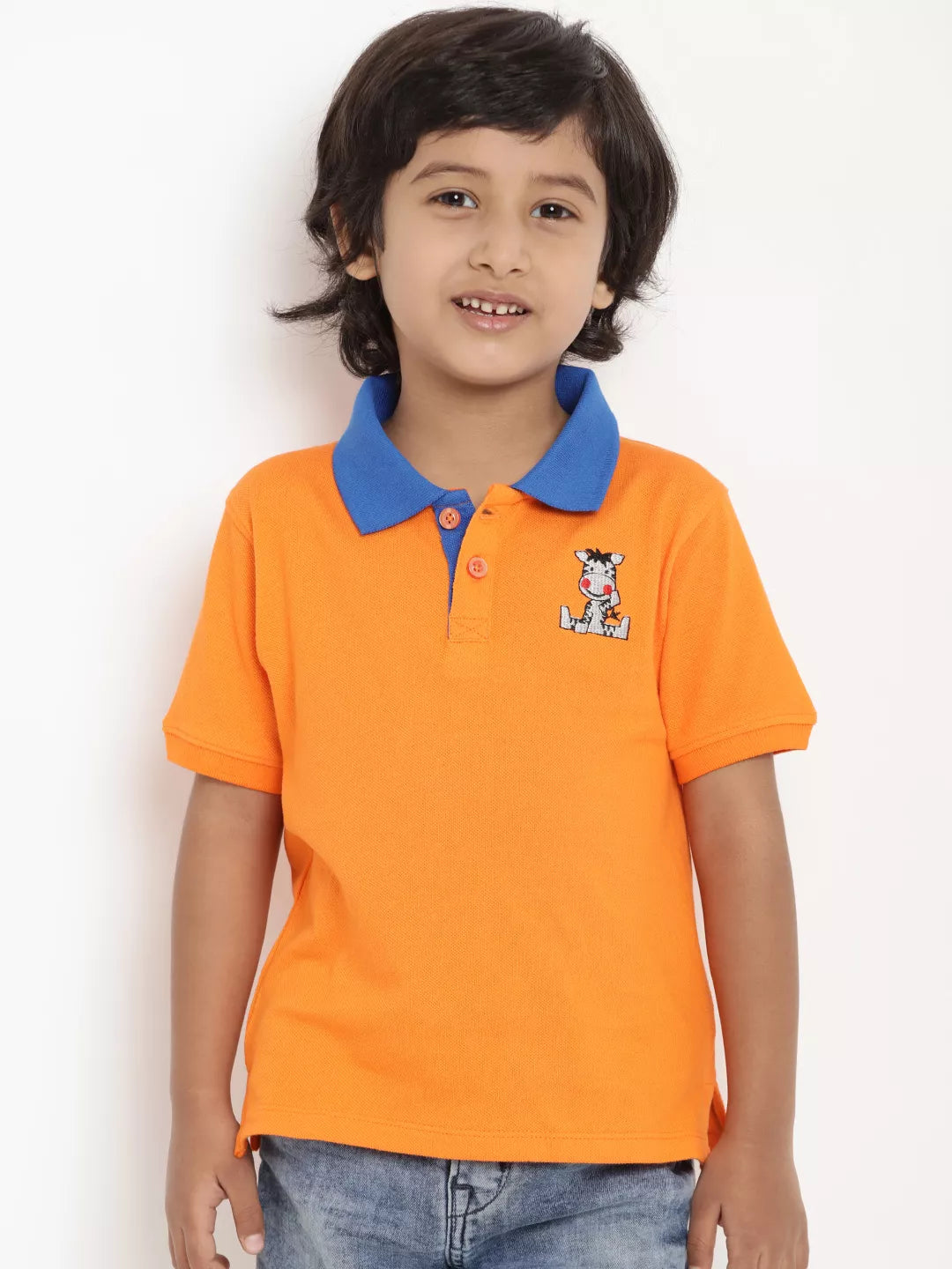 Child wearing an orange polo shirt with a blue collar against a white background