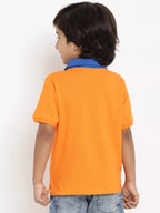 Child wearing an orange polo shirt with a blue collar against a white background