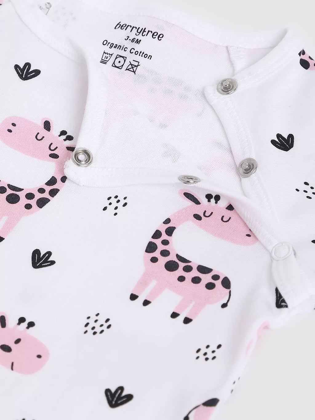 Baby onesie with pink giraffe design on a white background