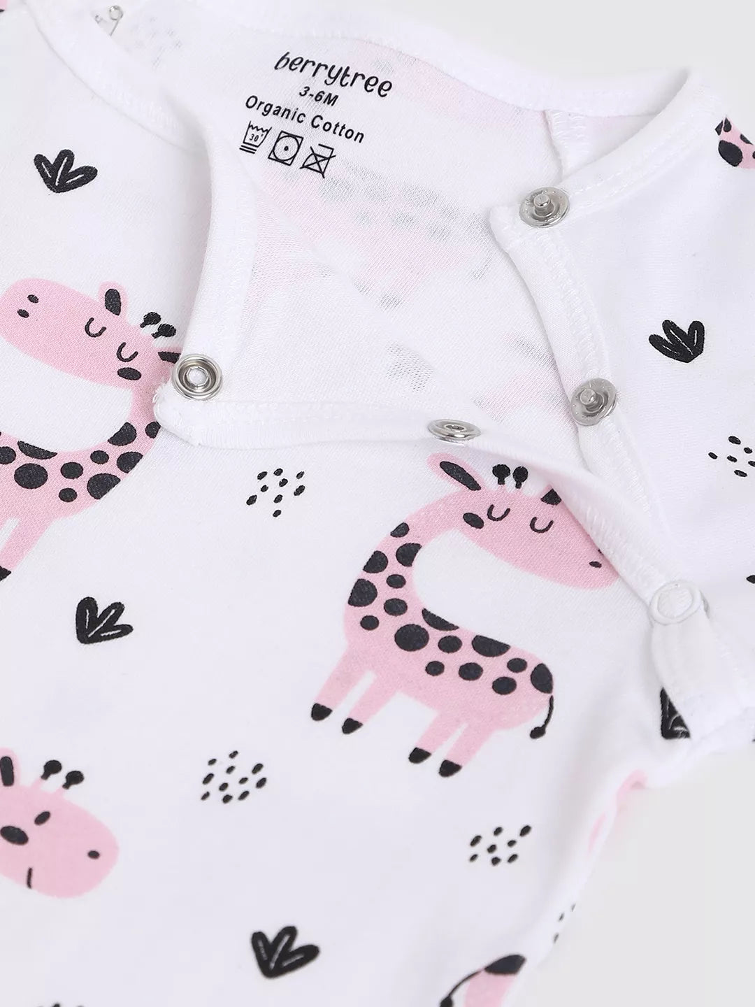 Baby onesie with pink giraffe design on a white background