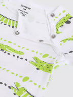 Baby romper with green and black crocodile pattern on a white background