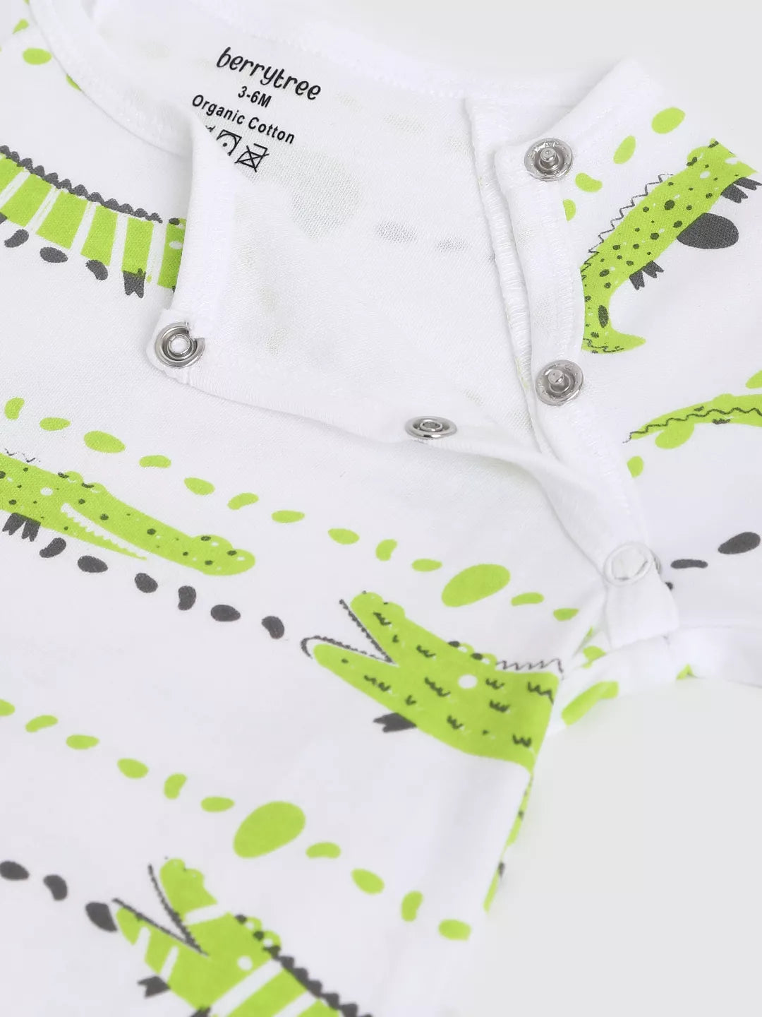 Baby romper with green and black crocodile pattern on a white background