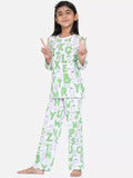 Child wearing a pajama set with alphabet pattern on a white background