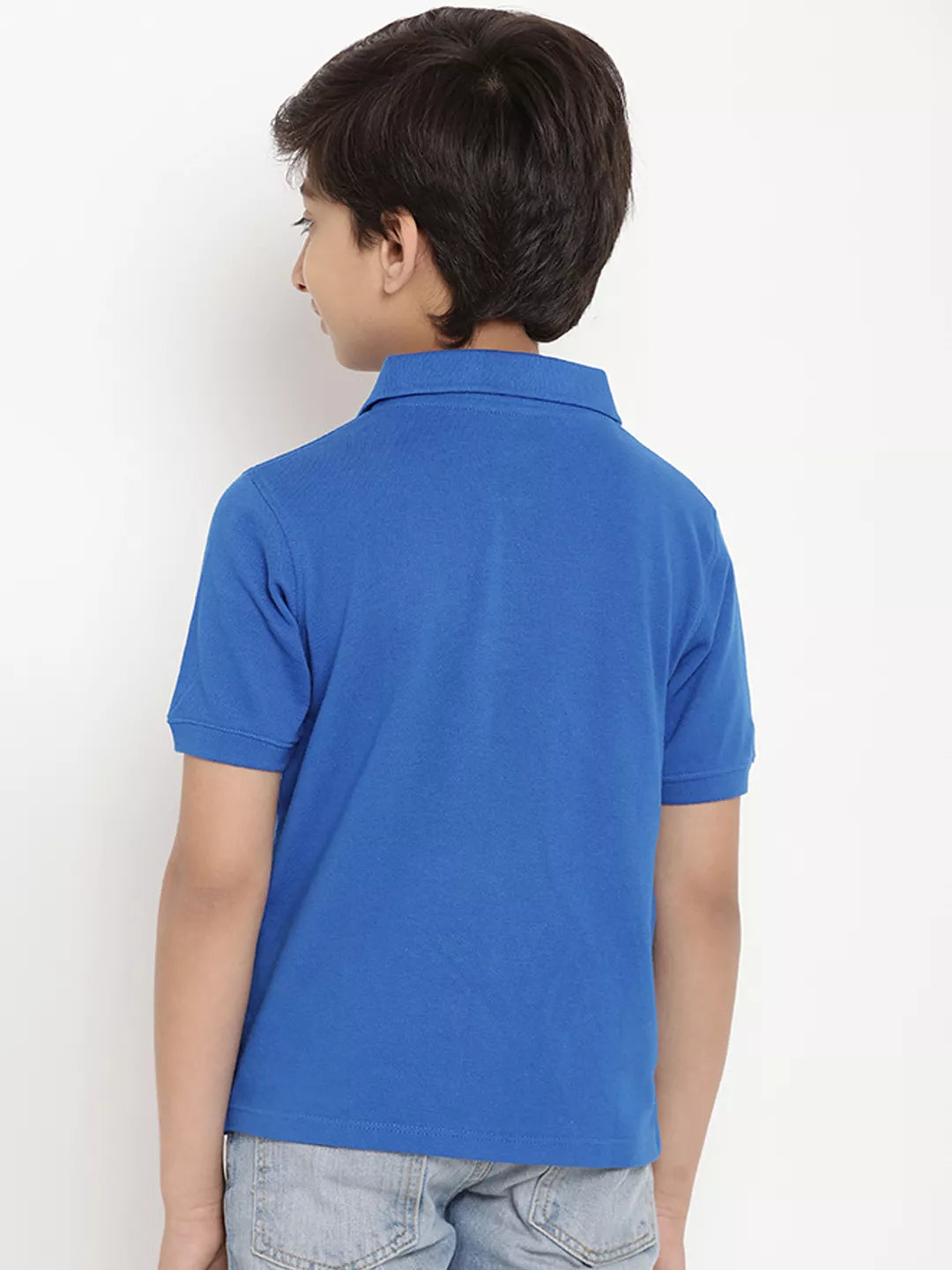 Child wearing a blue polo shirt against a white background