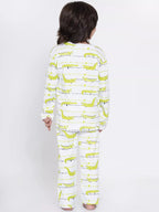 Person wearing a pajama set with green dinosaur pattern on a white background