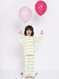 Child wearing a dinosaur-patterned onesie with pink and red balloons on a white background