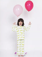 Child wearing a dinosaur-patterned onesie with pink and red balloons on a white background