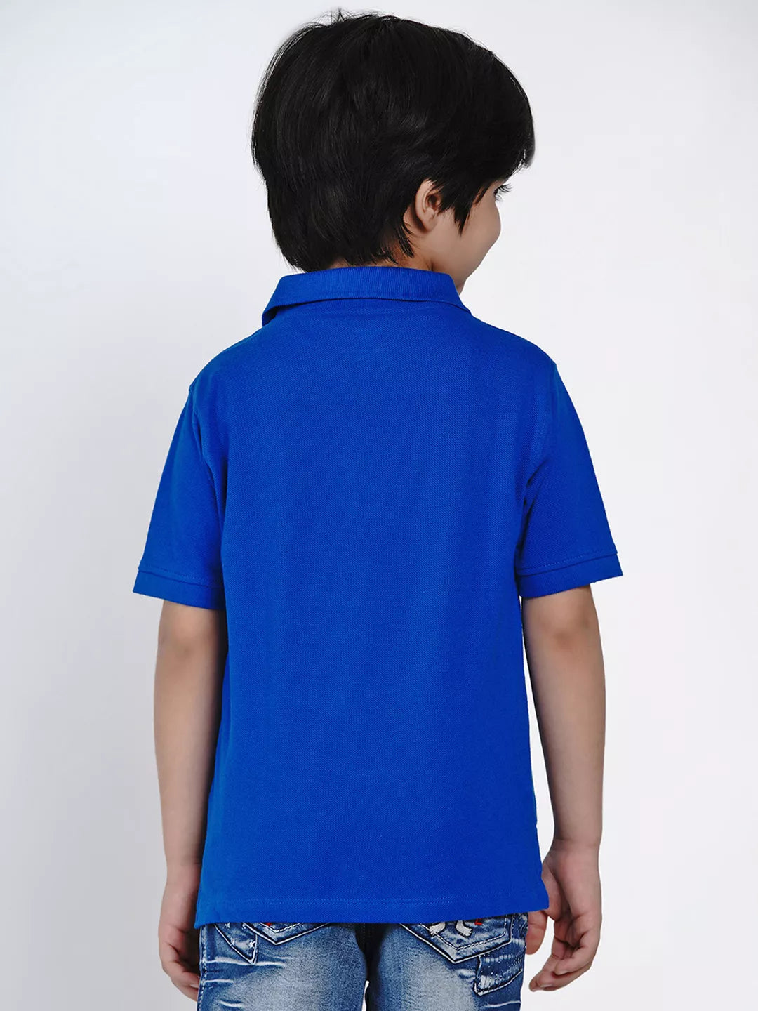 Child wearing a blue polo shirt on a white background