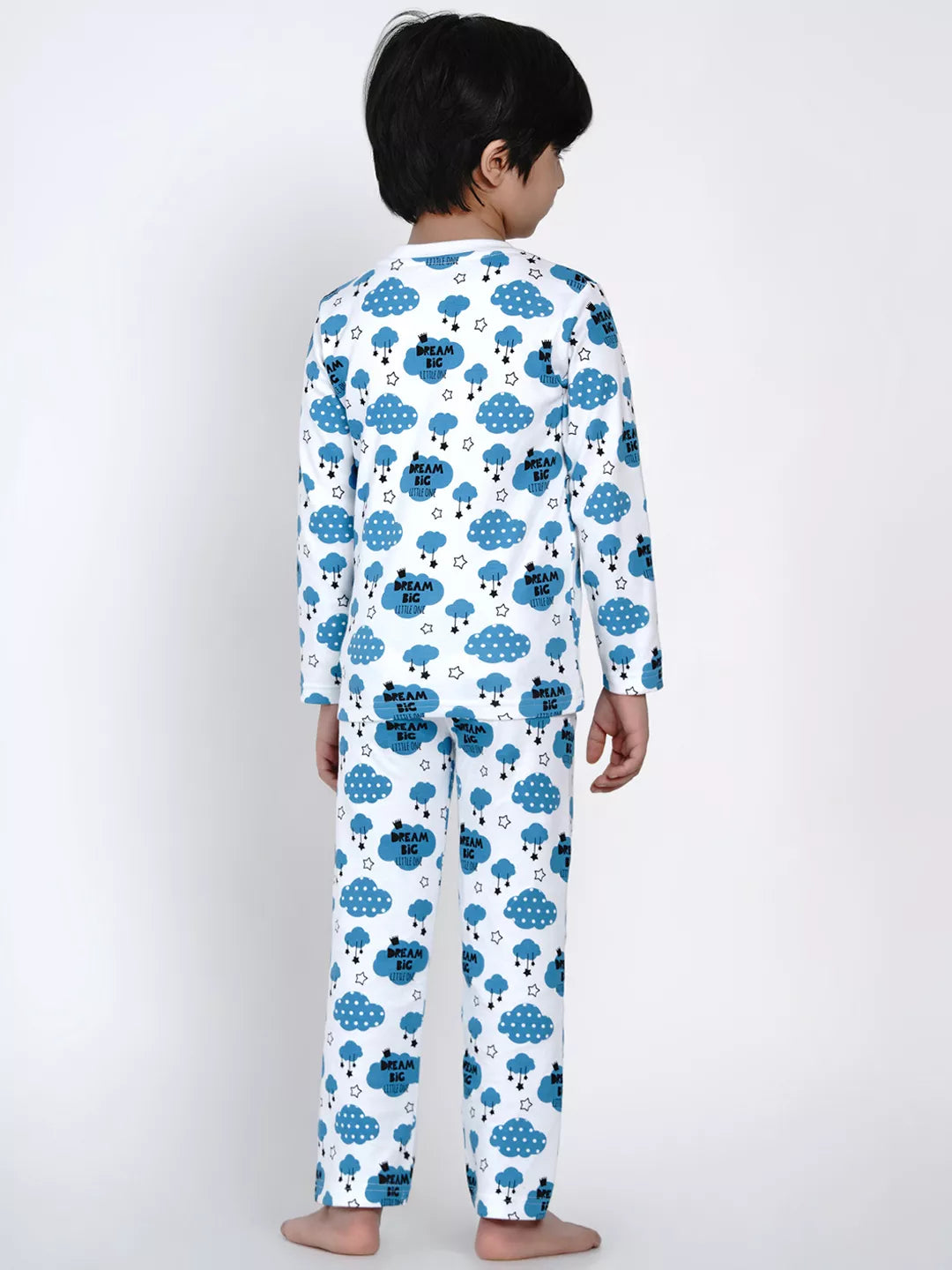 Child wearing a white onesie with blue cloud and sheep pattern on a white background