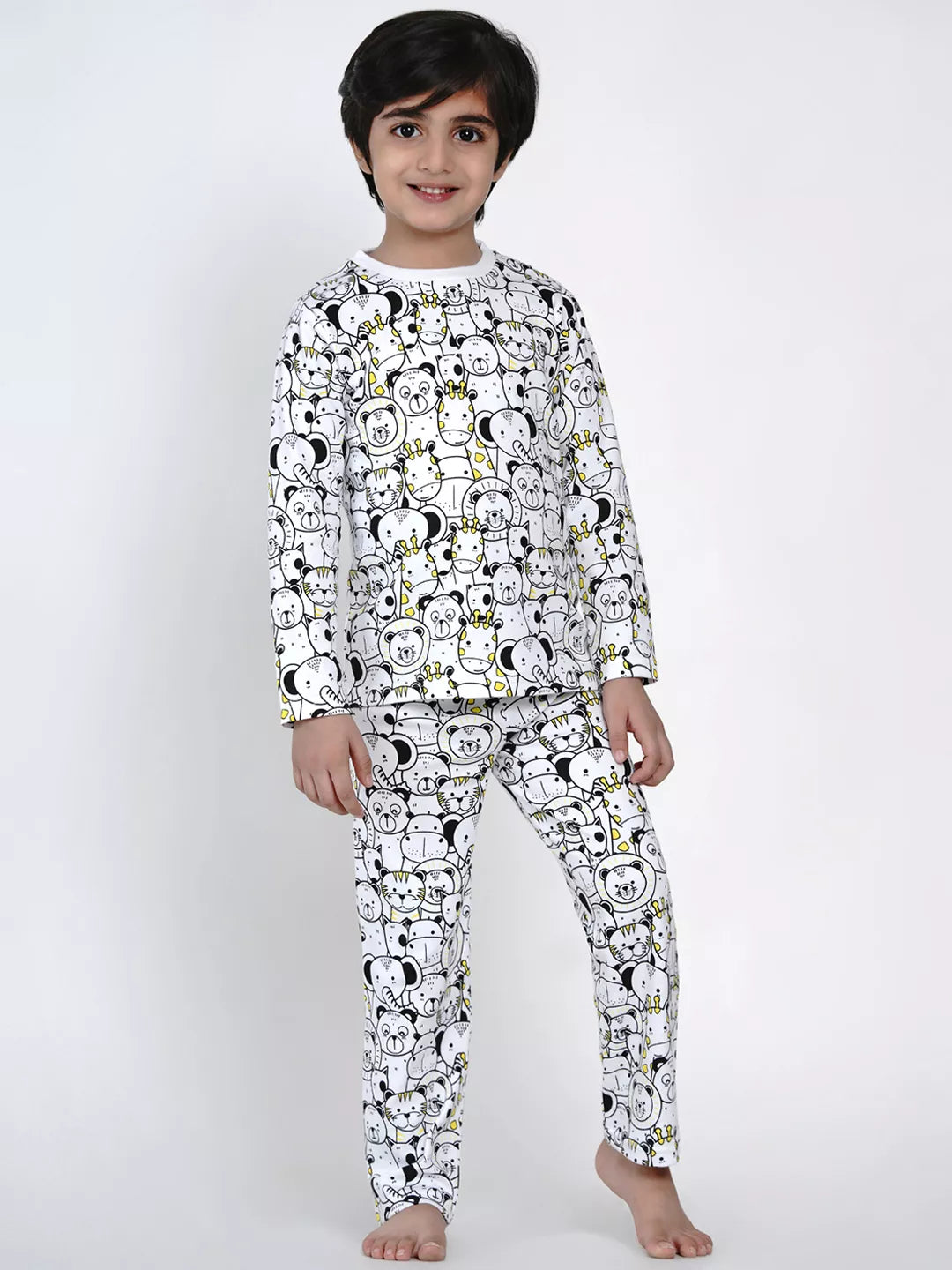 Child wearing a pajama set with a black and white pattern on a white background