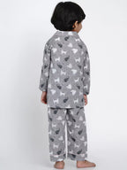 Child wearing gray pajamas with animal pattern on a white background