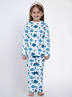Child wearing a blue and white pajama set with cloud and star pattern on a white background
