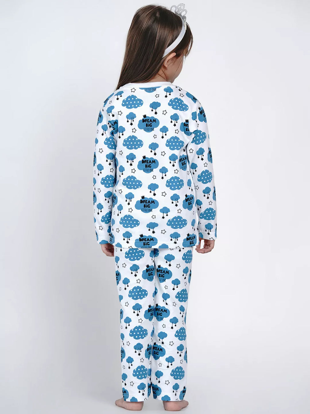 Child wearing a blue and white onesie with cloud and bear pattern on a white background