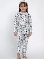 Child wearing a black and white patterned onesie on a white background