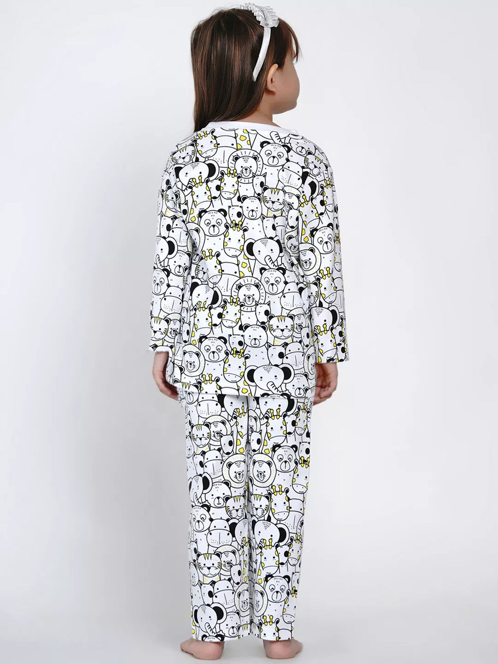 Child wearing a long-sleeve pajama set with cartoon character pattern on a white background