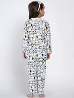 Child wearing a long-sleeve pajama set with cartoon character pattern on a white background