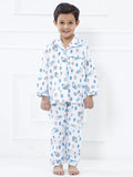 Child wearing a patterned pajama set on a white background