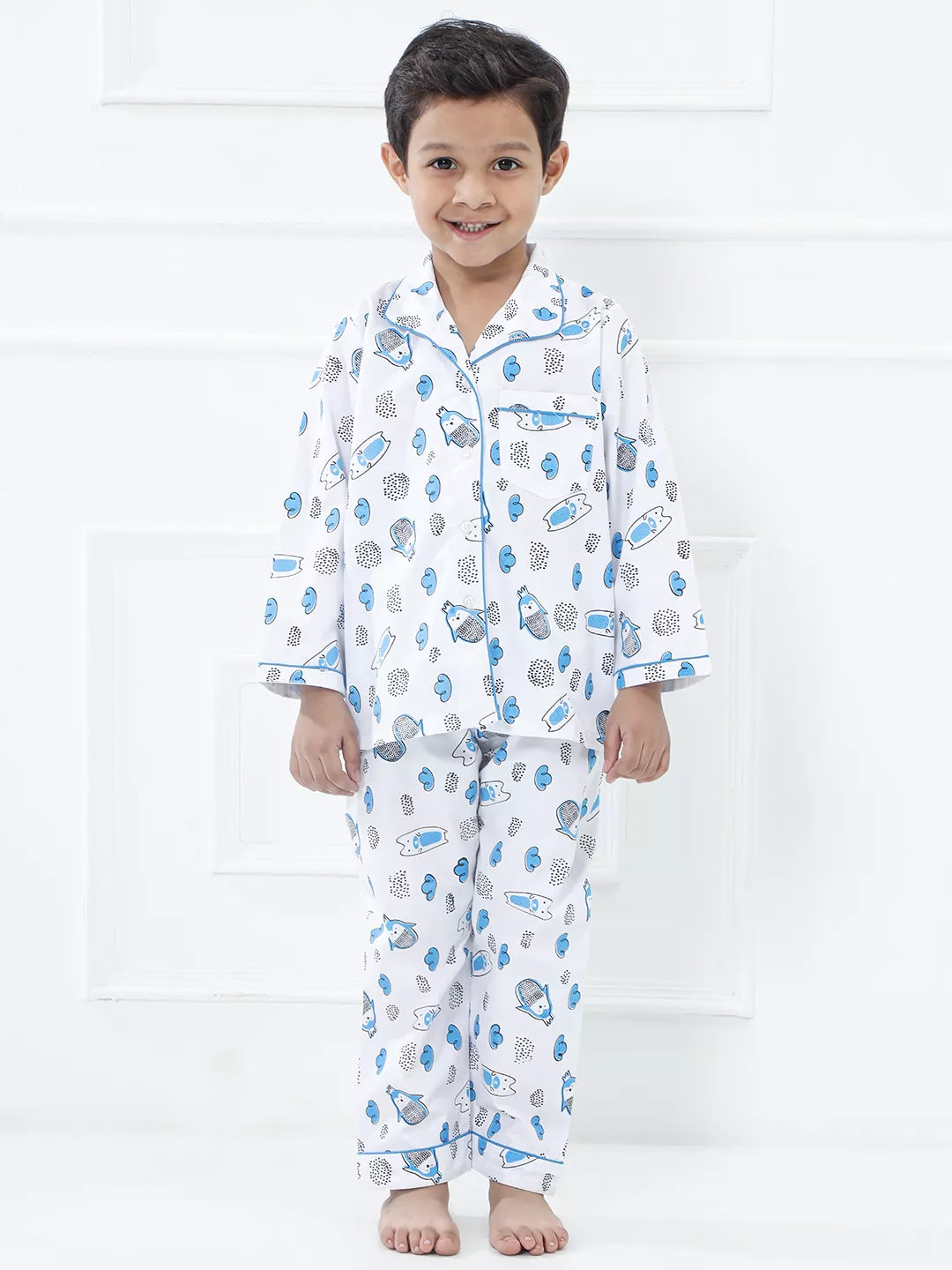 Child wearing a patterned pajama set on a white background