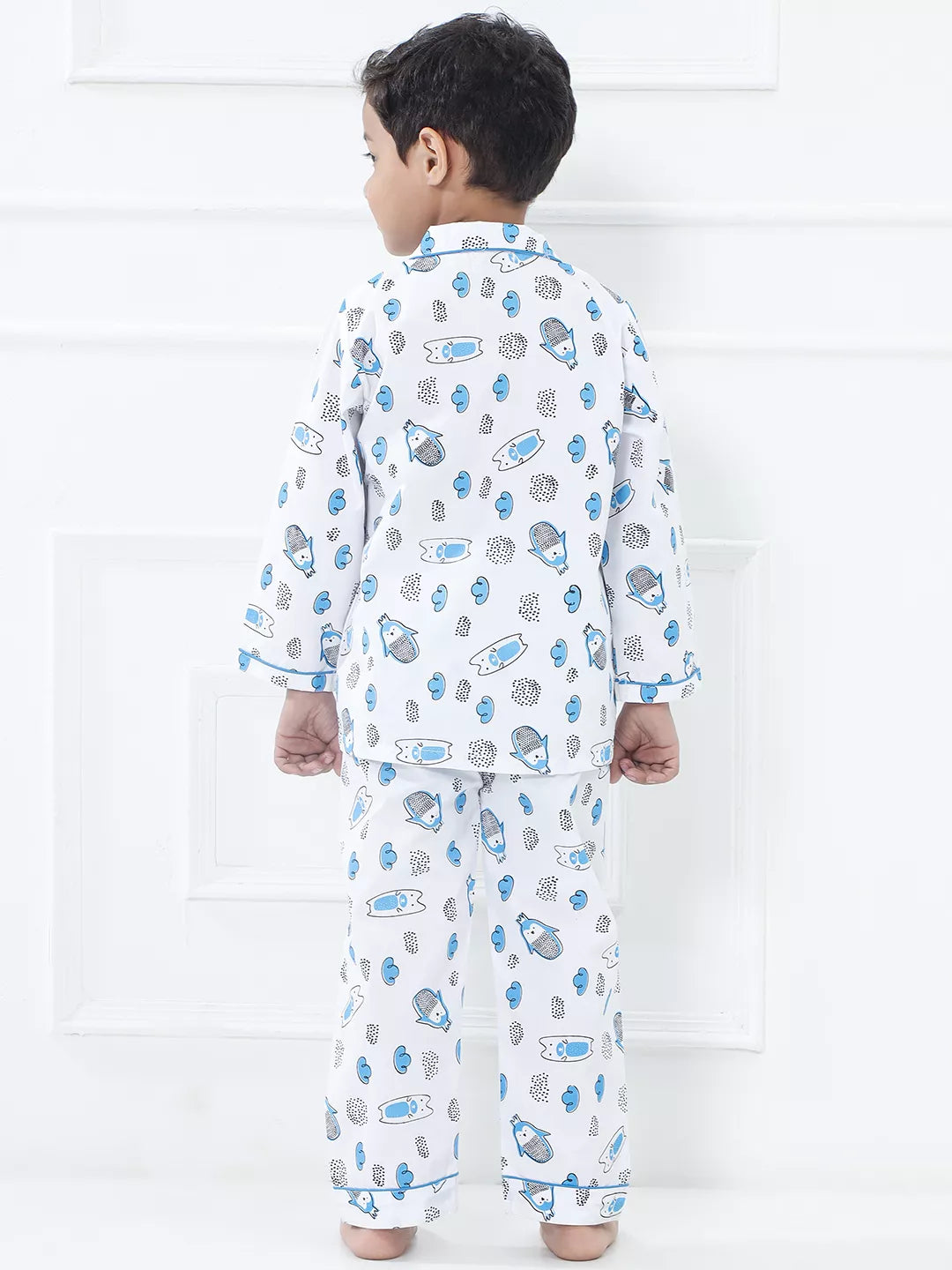 Child wearing a patterned pajama set against a white background