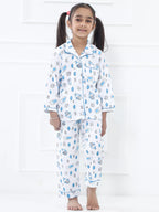 Girl wearing a space-themed pajama set on a white background
