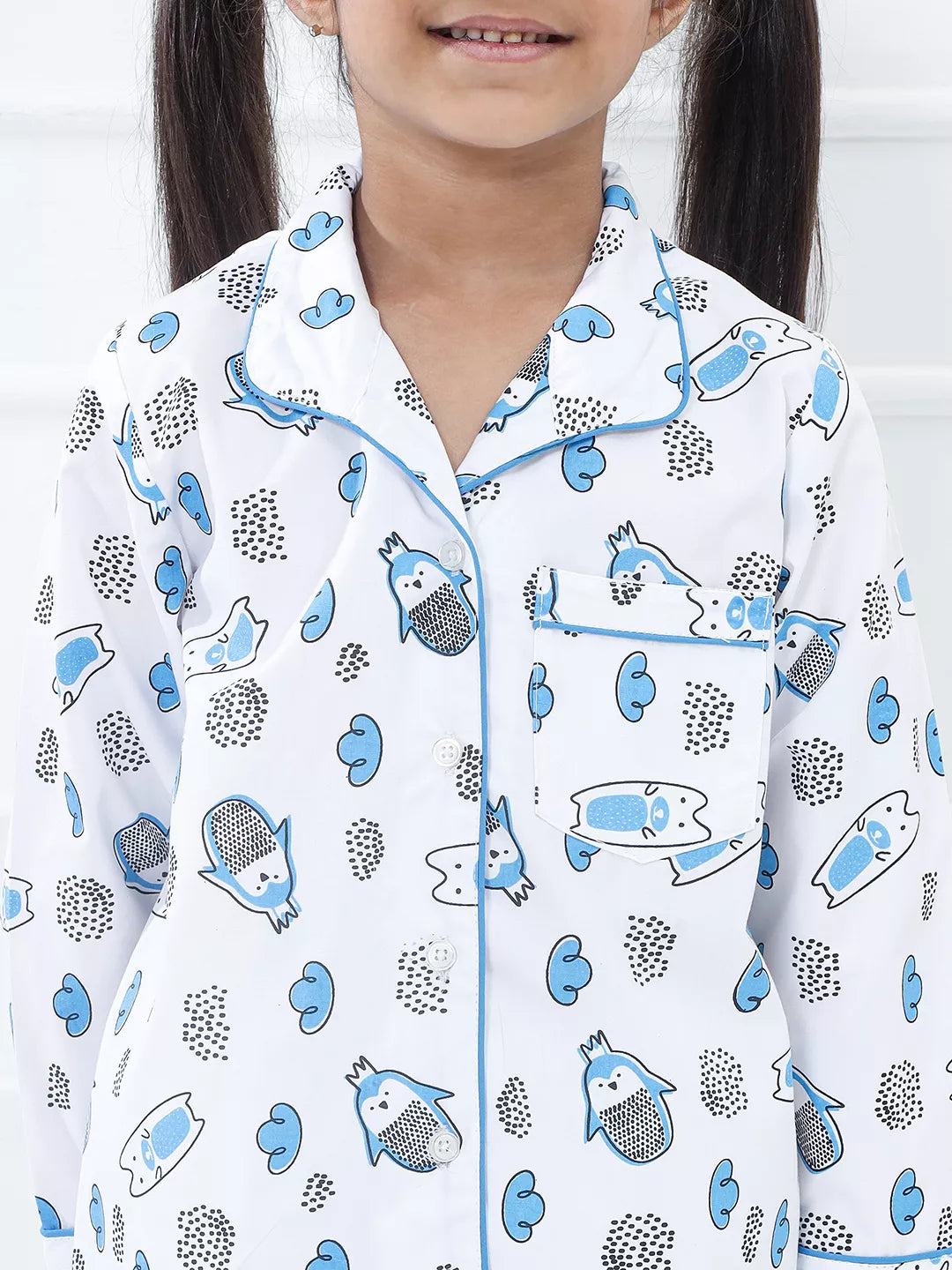 Children's pajama top with blue animal pattern on a white background