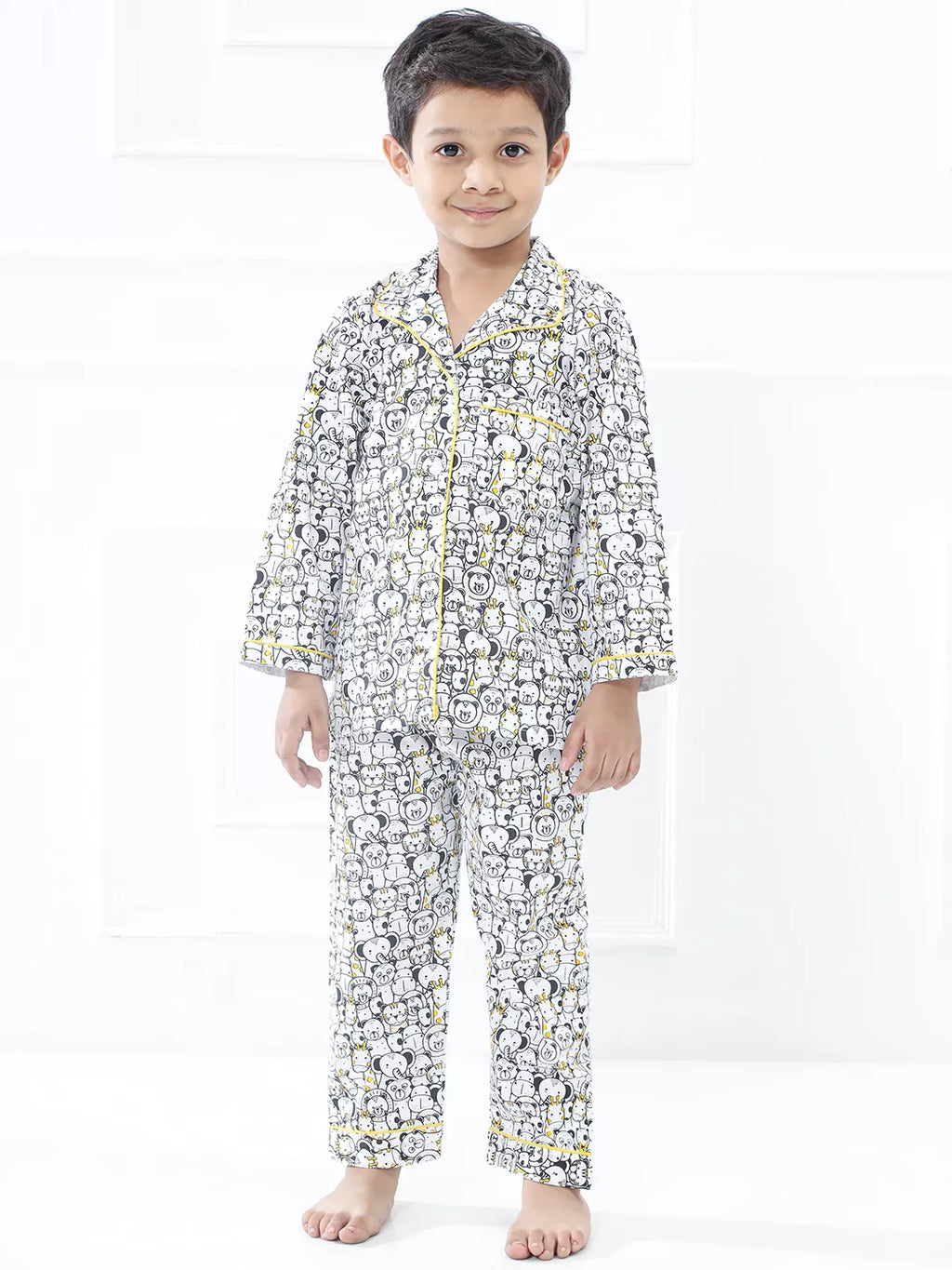 Child wearing a patterned pajama set on a white background
