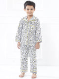 Child wearing a patterned pajama set on a white background