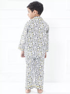 Child wearing a patterned onesie on a white background