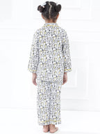 Child wearing a long, patterned dress on a white background