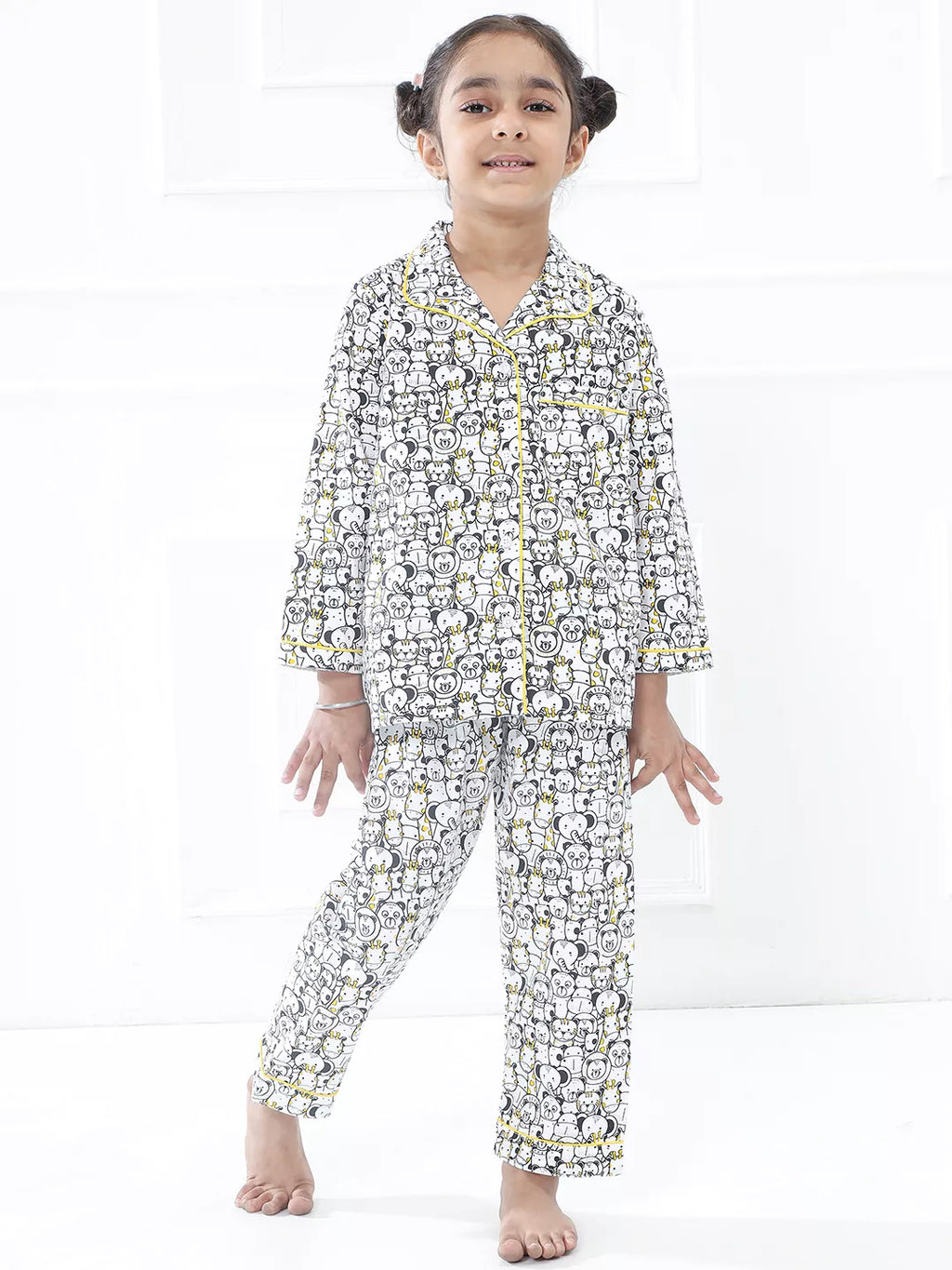 Young girl wearing a patterned pajama set on a white background