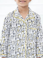 Child wearing a pajama set with bear pattern on a white background