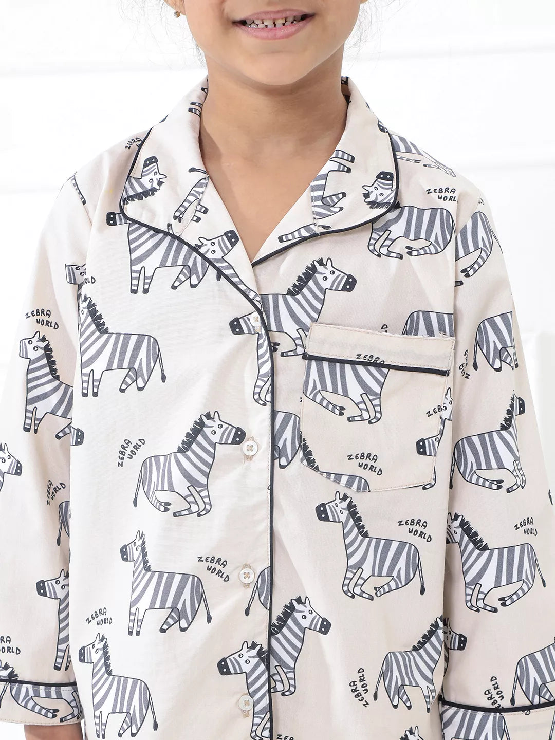 Child wearing a zebra-patterned shirt with a white background