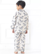 Child wearing zebra-patterned pajamas on a white background