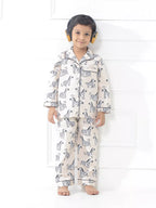 Child wearing zebra-patterned pajamas on a white background