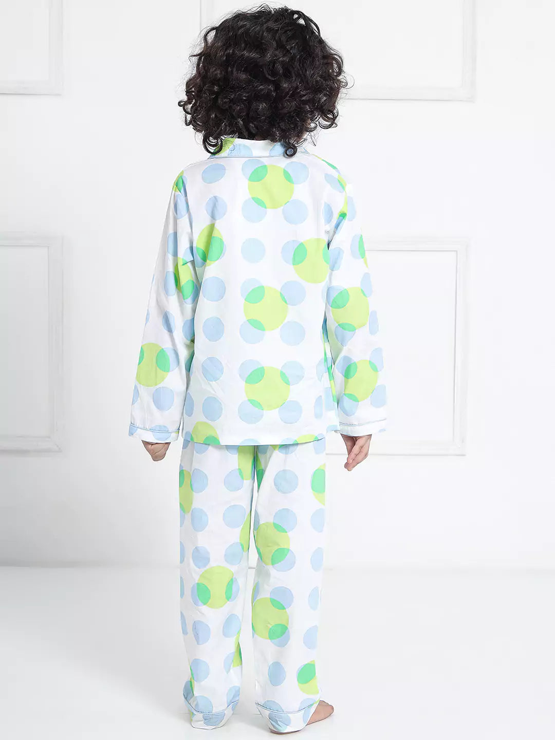 Child wearing a polka dot pajama set with a white background 2