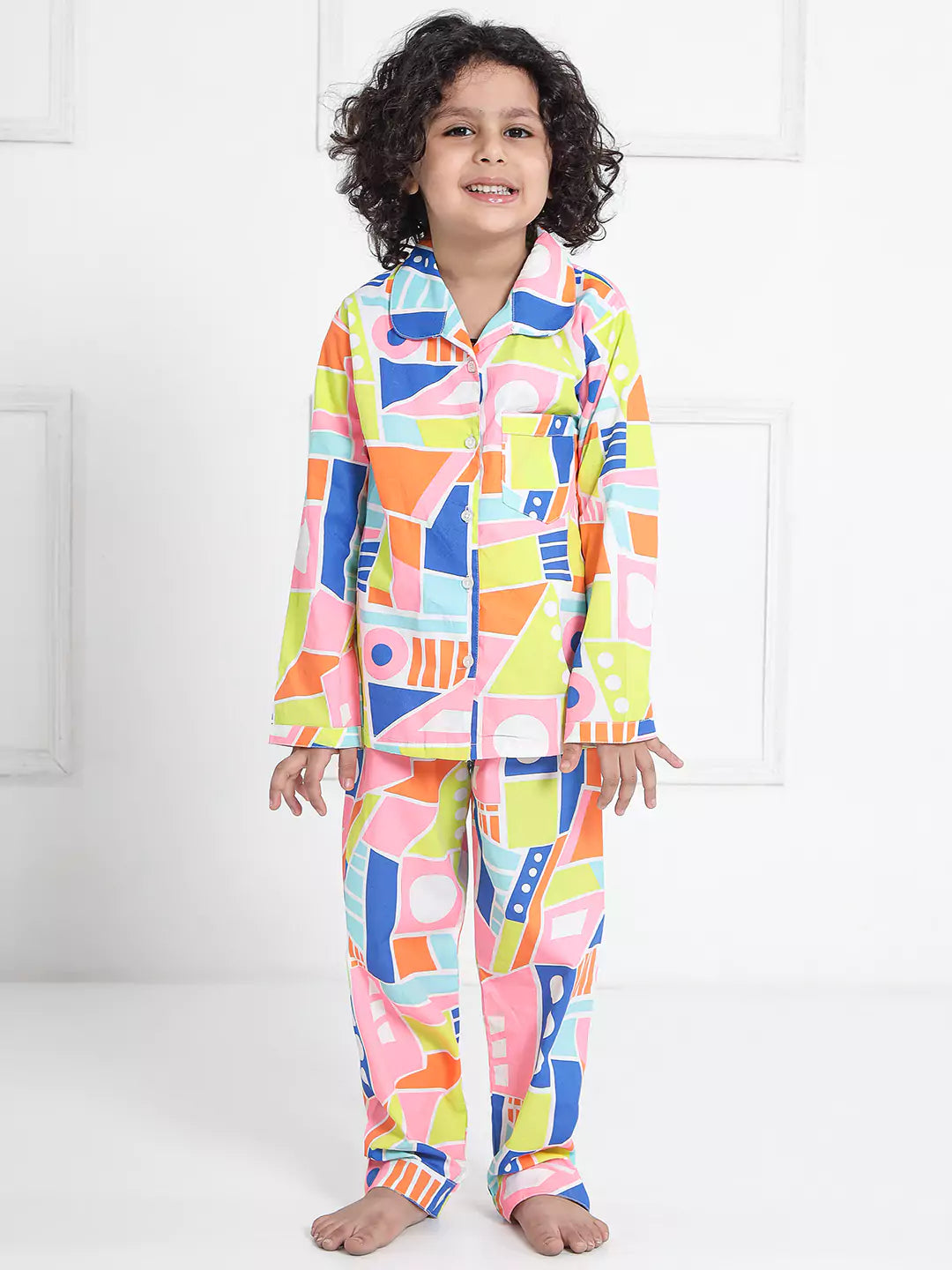 boy wearing colorful geometric patterned pajamas.