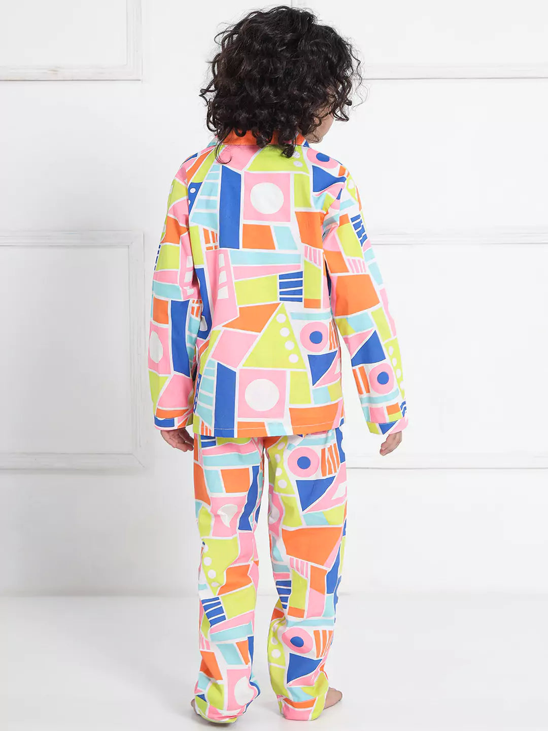 Child wearing a colorful geometric patterned nightsuit 