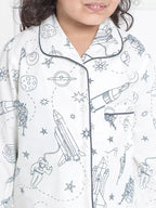 Children's pajama top with space-themed print on a white background