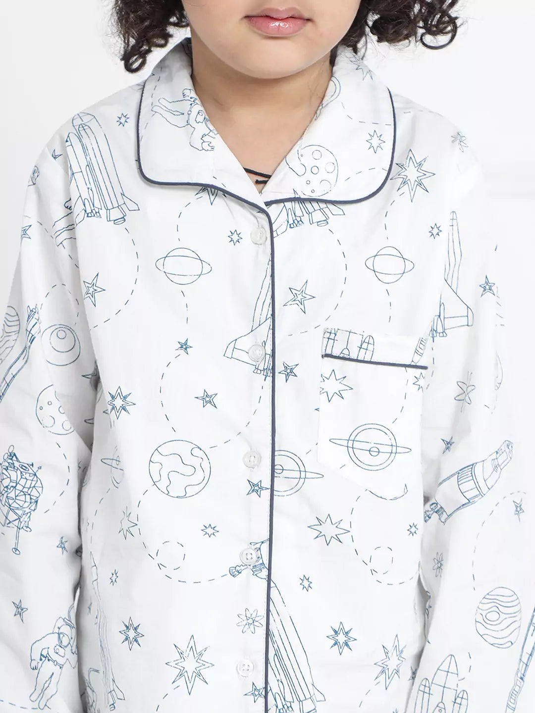 Child wearing a pajama set with space-themed design